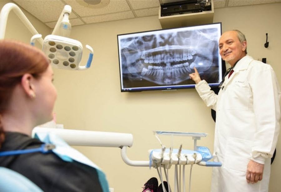 Doctor Makadia pointing to digital dental x-rays
