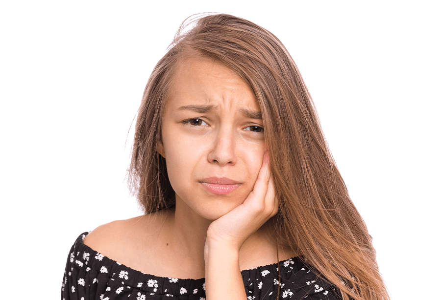 Woman in need of wisdom tooth extraction holding jaw in pain