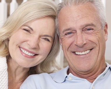 Man and woman sharing healthy smiles after dental care