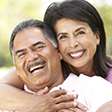 Husband and wife with dentures laughing