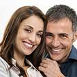 Husband and wife smiling after laser gum treatment