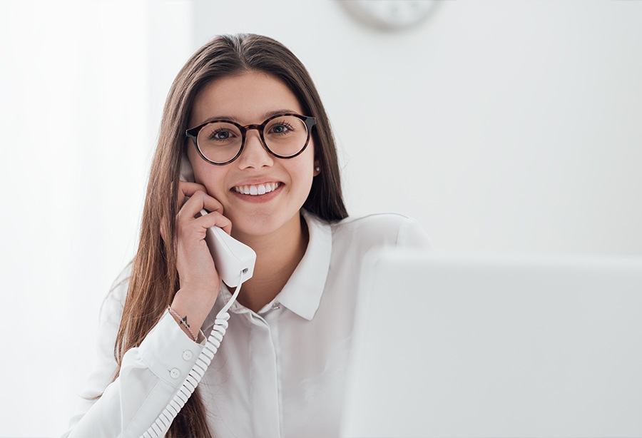 Woman using phone to contact our dental office in Bohemia New York