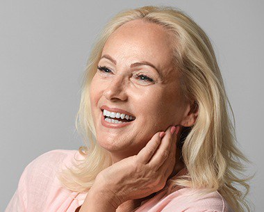 Woman showing off smile after dentures