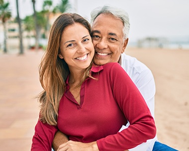 Man and woman with dentures smiling