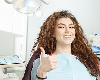 Dental tools laying on a stack of dollar bills