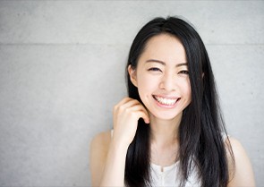 Woman smiling after surgical extraction