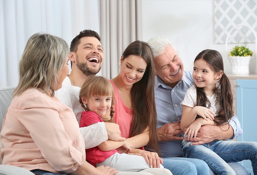 Three generations of family smiling after family dentistry visit