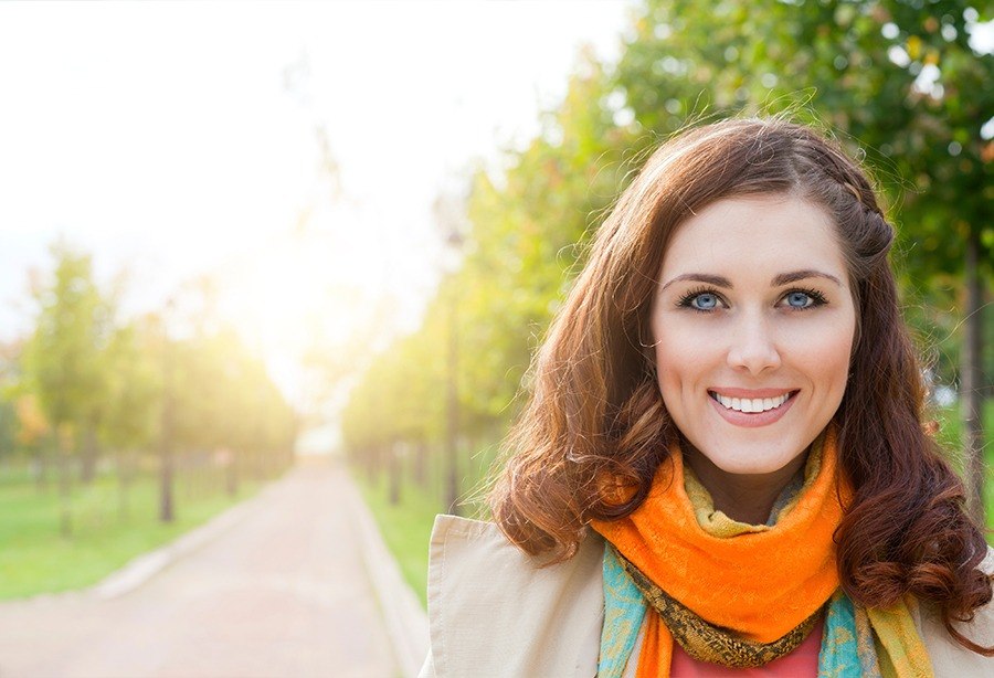 Woman sharing flawless smile after orthodontics treatment