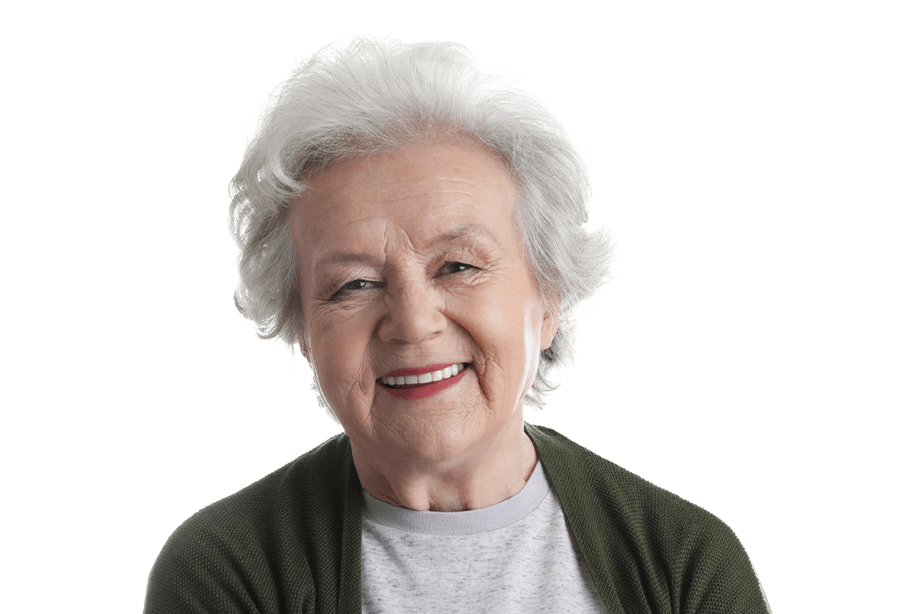 Older man and woman smiling after receiving dental implant retained dentures