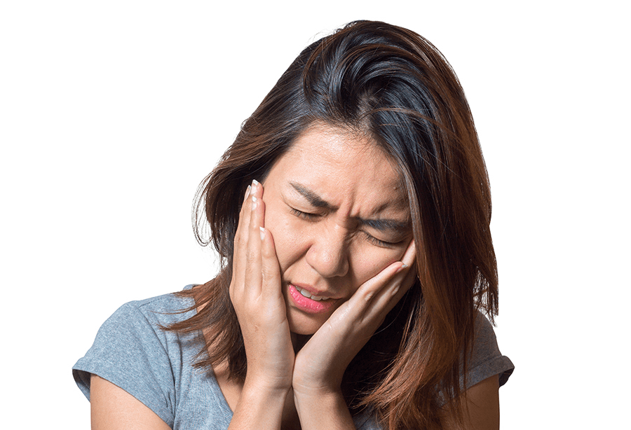 Woman holding cheek in pain before emergency dentistry
