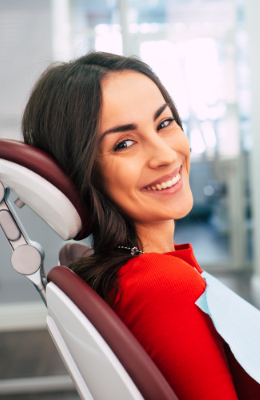 Smiling woman in dental chair for preventive dnetistry