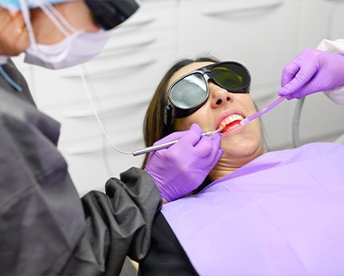 Patient receiving laser oral surgery
