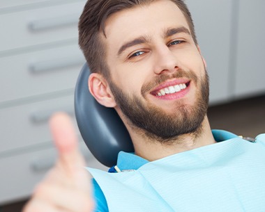 Man giving thumbs up after laser frenectomy