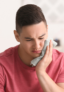 man holding his cheek in pain