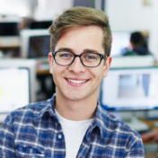 Young man in office smiling