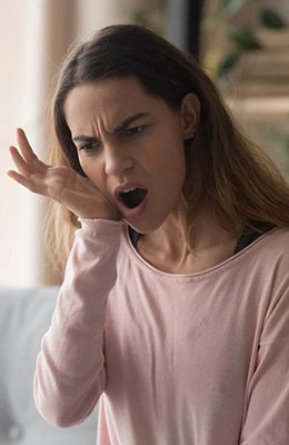 Patient in pain holding mouth