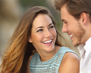 Woman with Lumineers smiling at man