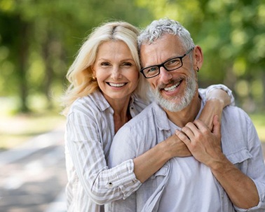 Happy older couple with beautiful, healthy teeth
