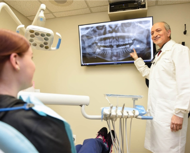 Doctor Makadia speaking with dental patient