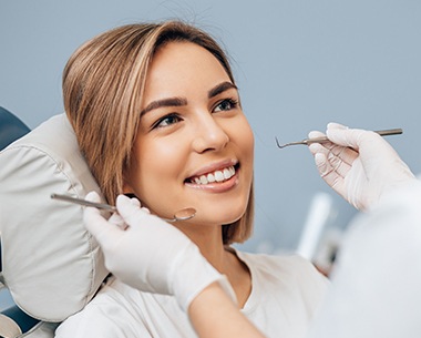 Woman receiving dental checkup and teeth cleaning