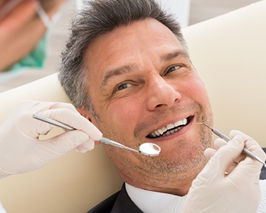 Man in dental chair for periodontal therapy