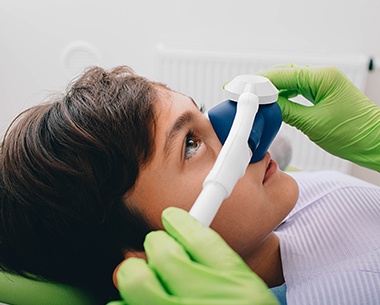 Dentist placing nitrous oxide dental sedation mask