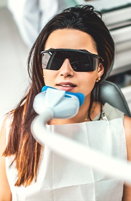 Woman receiving laser dentistry treatment