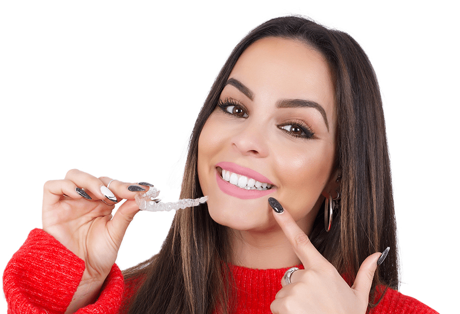 Smiling woman holding a SureSmile aligner