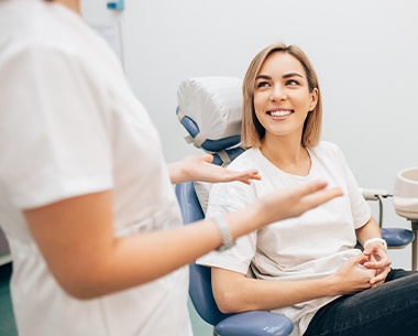 Woman talking to dentist about tooth colored fillings