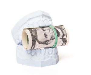 Plaster dental cast holding money