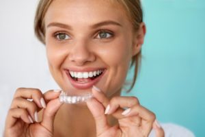 woman holding Invisalign