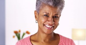 Older woman smiling after appointment with dentist.