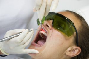 Woman at dentist for laser dentistry treatment.