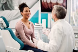 Patient talking to dentist, learning about gum disease therapy and cosmetic treatment