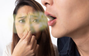 Person with bad breath, alienating those around them
