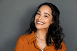 Smiling woman with beautiful teeth after visiting a cosmetic dentist