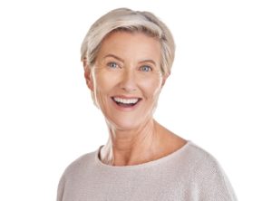 Smiling senior woman against neutral background