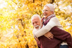 Senior couple happily playing outdoors