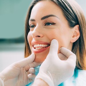 Dentist consulting with beautiful female patient